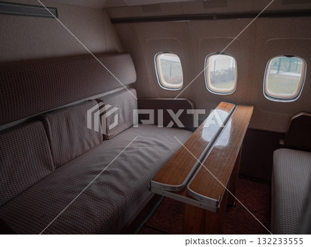 empty private sleeper cabin with sofa bed, folded armrests and soft linen, ambient light and padded surfaces create cozy retreat perfect for overnight flights, rest and relaxation empty private sleeper cabin with sofa bed, folded armrests and soft linen, ambient light and padded surfaces create cozy retreat perfect for overnight flights, rest and relaxation 132233555