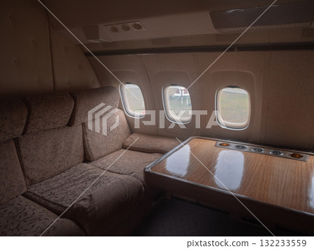 exclusive private jet experience, private airline lounge featuring plush seats and stunning views, upscale private jet lounge offering sophisticated seating and breathtaking scenic vistas 132233559