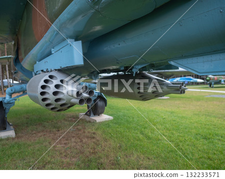 military plane with rocket launchers, view of tactical aircraft showcasing rockets and rugged design, detailed shot of military aircraft parked with weaponry and weathered exterior elements military plane with rocket launchers, view of tactical aircraft showcasing rockets and rugged design, detailed shot of military aircraft parked with weaponry and weathered exterior elements 132233571