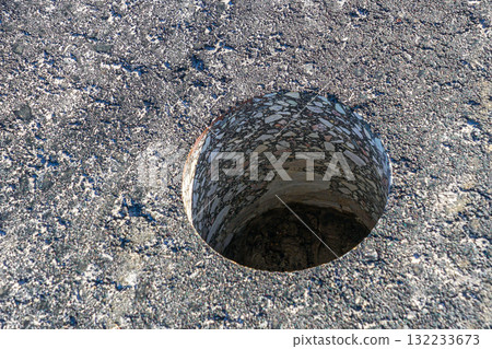 Core drilling in asphalt pavement to test thickness and quality of road construction material 132233673