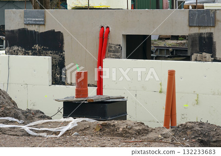 Building foundation with insulation and utility pipes at construction site, structural groundwork Building foundation with insulation and utility pipes at construction site, structural groundwork 132233683
