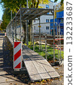 Safe pedestrian walkway with protective scaffolding along construction site in urban street area 132233687