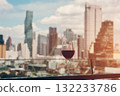 red wine on terrace with Bangkok city skyline at sunset, cocktail on rooftop, vibrant cityscape and luxury panorama view 132233786