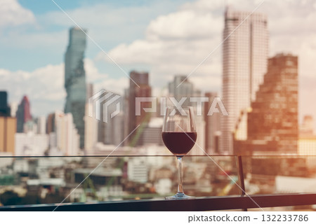 red wine on terrace with Bangkok city skyline at sunset, cocktail on rooftop, vibrant cityscape and luxury panorama view red wine on terrace with Bangkok city skyline at sunset, cocktail on rooftop, vibrant cityscape and luxury panorama view 132233786