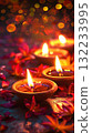 A close up Diya oil lamps in small bowls with red flowers in gold background. Warm and inviting Diwali mood 132233995