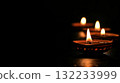 Diya oil lamps against dark background. Warm and inviting Diwali mood. Copy place 132233999