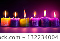 A row of candles with different colors and designs. The candles are lit and the image has a warm and cozy feelin 132234004