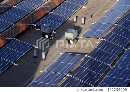 Solar panels on roof of apartment housing building, renewable green sustainable energy concept, water cooling, aerial view 132234099