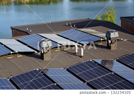 Solar panels on roof of apartment housing building, renewable green sustainable energy concept, water cooling, aerial view 132234105