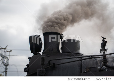 Thick smoke rises from the chimney of a historic black steam locomotive at the Moscow Railway Museum Turntable Thick smoke rises from the chimney of a historic black steam locomotive at the Moscow Railway Museum Turntable 132234156