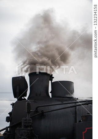 Thick smoke rises from the chimney of a historic black steam locomotive at the Moscow Railway Museum Turntable Thick smoke rises from the chimney of a historic black steam locomotive at the Moscow Railway Museum Turntable 132234158
