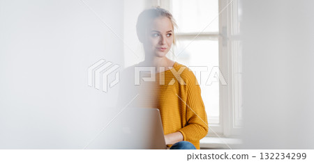 Banner of student during study session, working on laptop. 132234299