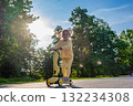 Scooter child. Girl riding scooter toddler. Yellow outdoor activity park road. 132234308