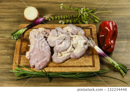 Cow bowels presented on a wooden board with ingredients, ready to grill Cow bowels presented on a wooden board with ingredients, ready to grill 132234446