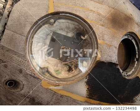aged ship window, rusty porthole with debris, weathered ship window showing signs of neglect, old rusted porthole on vessel with debris and signs of decay 132234498