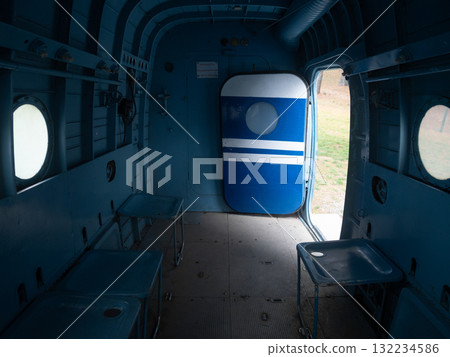 abandoned aircraft with rusty fittings, decrepit airplane interior featuring corroded components and open hatch, derelict industrial aircraft interior showcasing rusted fixtures and open 132234586