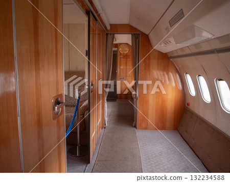 luxury jet corridor, elegant woodpaneled jet interior, private jet corridor with plush carpet and brass fixtures, sophisticated woodpaneled private jet hallway with brass accents and cozy 132234588
