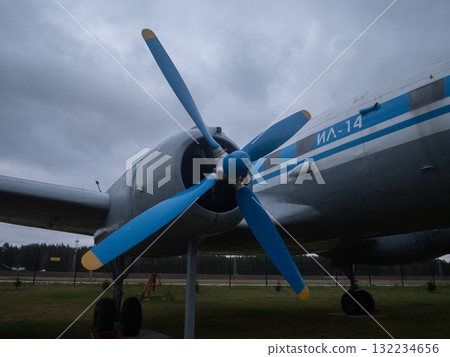 fourblade propeller centered on fuselage, precise mechanical symmetry and polished hub against stormy sky, highlighting engineering detail, rivets and reflective metal in museum setting fourblade propeller centered on fuselage, precise mechanical symmetry and polished hub against stormy sky, highlighting engineering detail, rivets and reflective metal in museum setting 132234656
