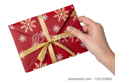 Hand holding festive red envelope with gold foil snowflake designs, isolated on transparent background for christmas or chinese new year celebrations Hand holding festive red envelope with gold foil snowflake designs, isolated on transparent background for christmas or chinese new year celebrations 132234662