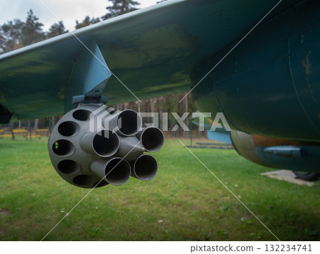 close perspective on rocket launcher tubes beneath wing, inspection context with alignment marks and wear, museum field setting with pine backdrop, maintenance checklist implied, engineering close perspective on rocket launcher tubes beneath wing, inspection context with alignment marks and wear, museum field setting with pine backdrop, maintenance checklist implied, engineering 132234741