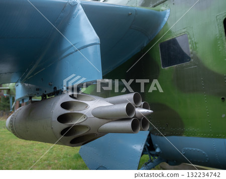 camouflage wing with rocket pod, multitube rocket launcher on camouflaged aircraft wing closeup view, detailed image of weapon pod beneath camouflage wing showing rocket launcher 132234742