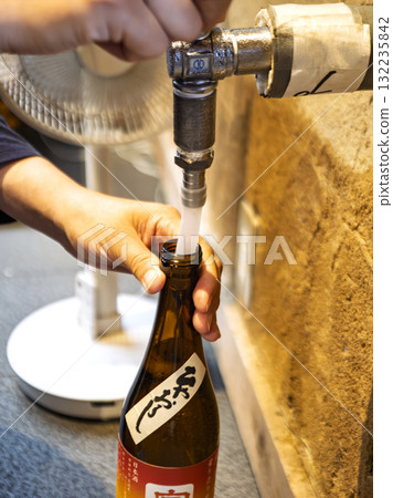A drink poured from the spirit of the sake brewery 132235842