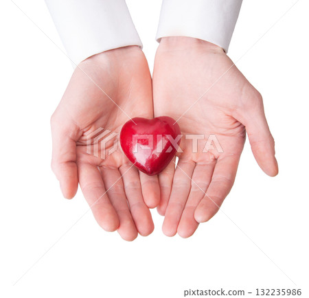 Close-up of hands gently holding heart-shaped red apple, symbolizing health, care, love donation, isolated on white. Health insurance or love concept Close-up of hands gently holding heart-shaped red apple, symbolizing health, care, love donation, isolated on white. Health insurance or love concept 132235986
