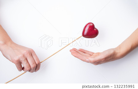 Health insurance or love concept. Hands Holding Heart-Shaped Apple. Close-up hands gently holding 132235991
