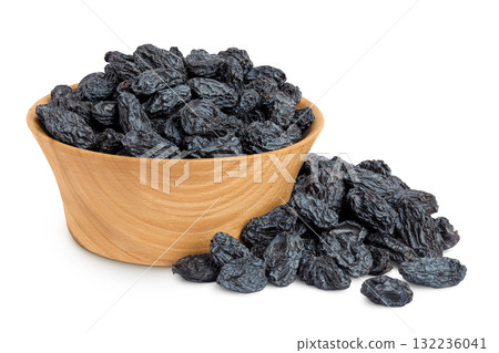 black raisins in wooden bowl isolated on white background 132236041