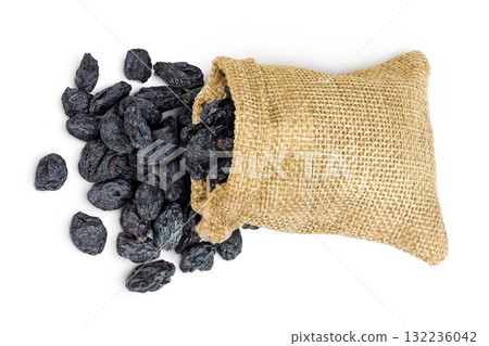 black raisins in bag isolated on white background. Top view. Flat lay black raisins in bag isolated on white background. Top view. Flat lay 132236042