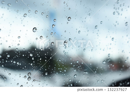 water drop on mirror in defocused car parking background 132237927