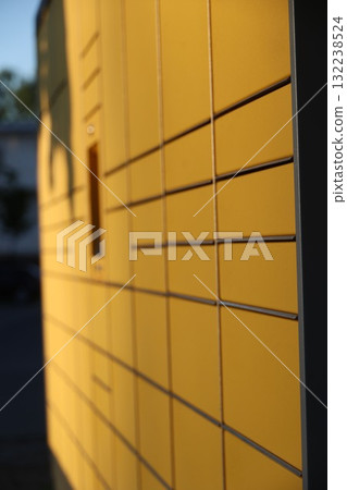 A yellow building with a lot of windows and a shadow on it A yellow building with a lot of windows and a shadow on it 132238524