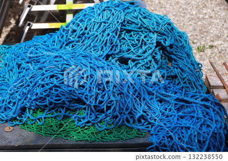 A pile of blue and green ropes 132238550