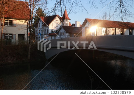 A bridge over a river with a house in the background A bridge over a river with a house in the background 132238579