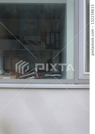 A window with a pair of scissors on the sill A window with a pair of scissors on the sill 132238613