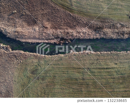 Field with a river running through it Field with a river running through it 132238685