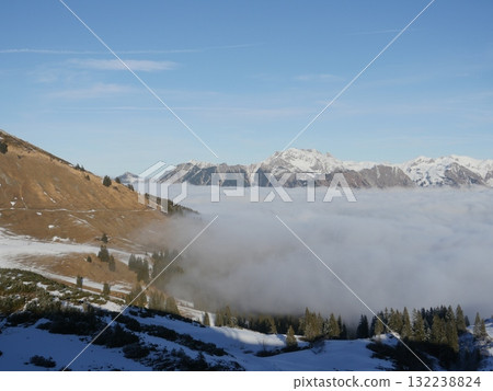 The sky is clear and the mountains are covered in snow 132238824