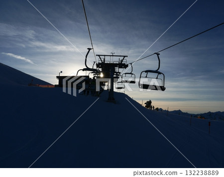 A ski lift with a few people on it 132238889