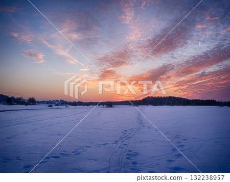 A beautiful sunset over a snow-covered field A beautiful sunset over a snow-covered field 132238957