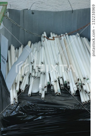 Pile of white light bulbs are in a black plastic bag Pile of white light bulbs are in a black plastic bag 132238969