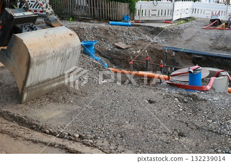 Construction site with a large excavator digging a hole 132239014