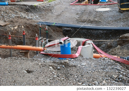 Blue and red pipe is tied to a cement block Blue and red pipe is tied to a cement block 132239027