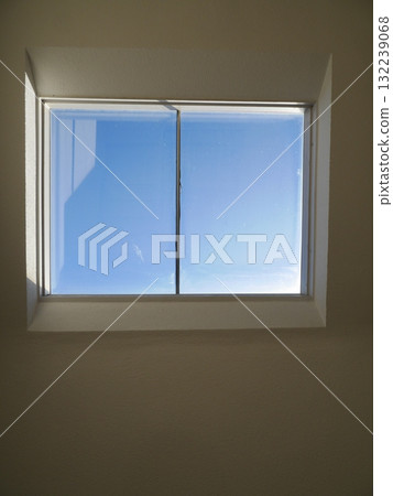 Window with a clear glass pane and a blue sky outside Window with a clear glass pane and a blue sky outside 132239068