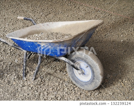 Blue wheelbarrow filled with gravel Blue wheelbarrow filled with gravel 132239124