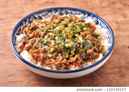 Fried minced pork with chive flower and black bean sauce over rice 132239157