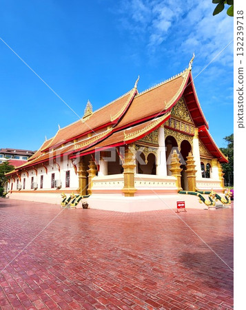 Laos: Temple architecture with beautiful roof decorations and the side of the main hall of Wat Si Muang Laos: Temple architecture with beautiful roof decorations and the side of the main hall of Wat Si Muang 132239718