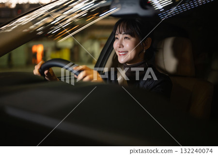 A woman driving a car 132240074