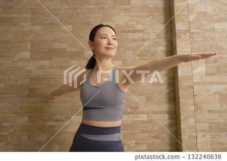 Woman in her 20s, hot yoga Woman in her 20s, hot yoga 132240636