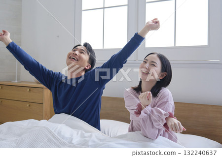 A couple in bed after waking up 132240637