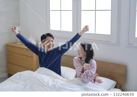 A couple in bed after waking up 132240639